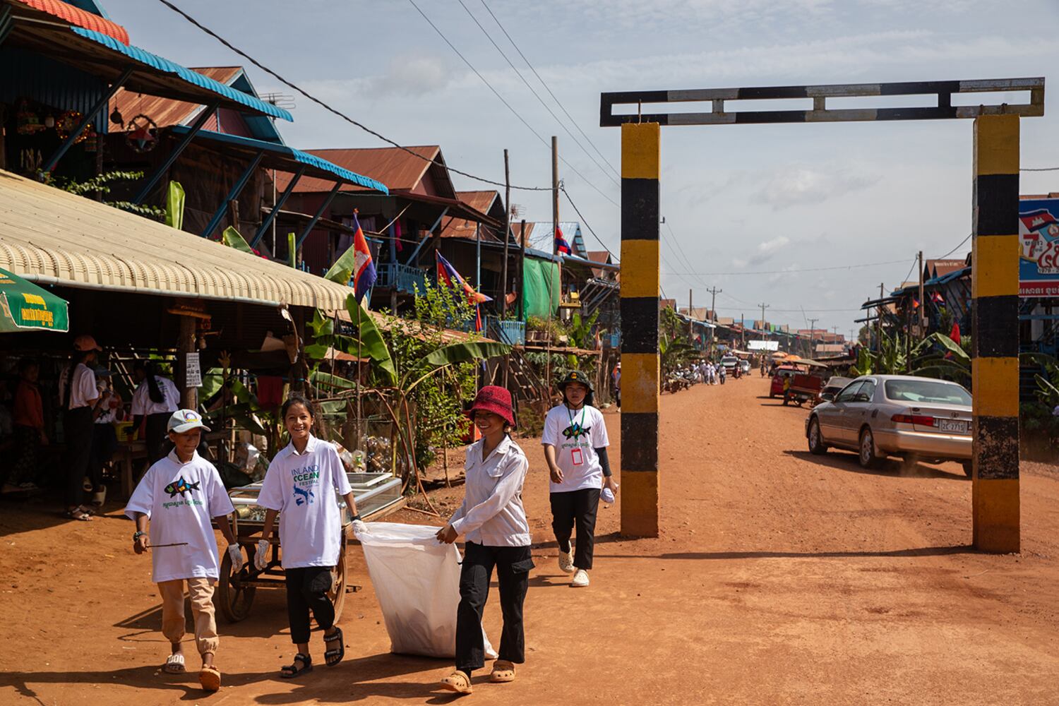 Students volunteering with the NGO2 BambooShoot Foundation pick up trash in Kampong Phluk, one of the floating villages on Tonle Sap Lake in Cambodia.