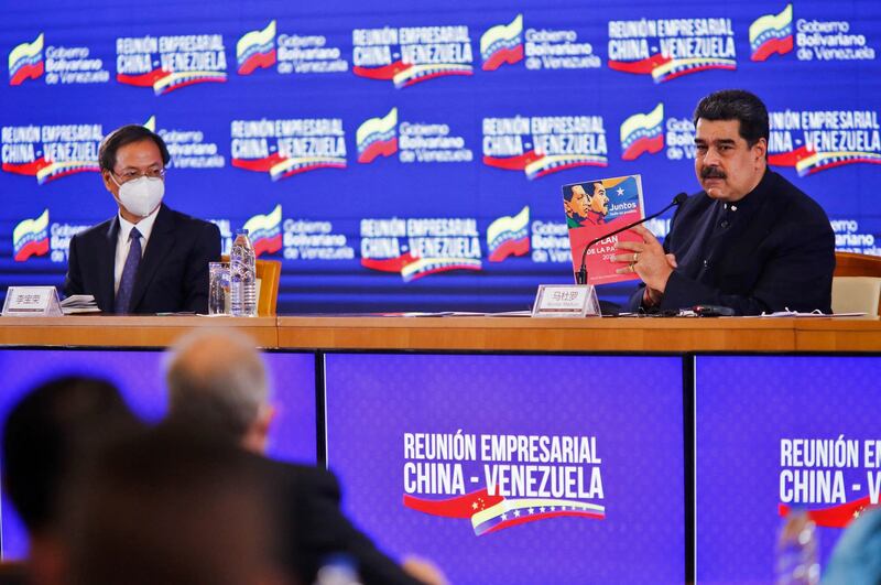 Handout photo released by the Venezuelan Presidency showing Venezuela's President Nicolas Maduro and Chinese Ambassador in Venezuela Li Baorong (L) during a meeting with Chinese business representatives in Caracas, Nov. 6, 2020. Credit: AFP