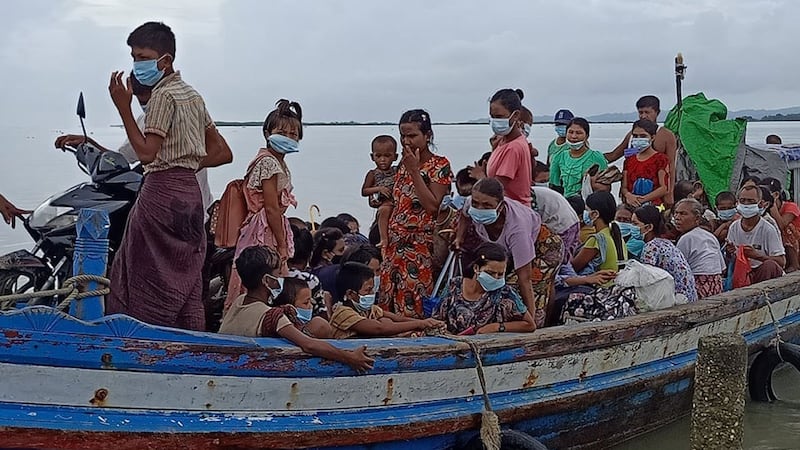 A boat carrying villagers fleeing conflict in Myanmar's Rakhine State at the state capital Sittwe, Sept 23, 2020