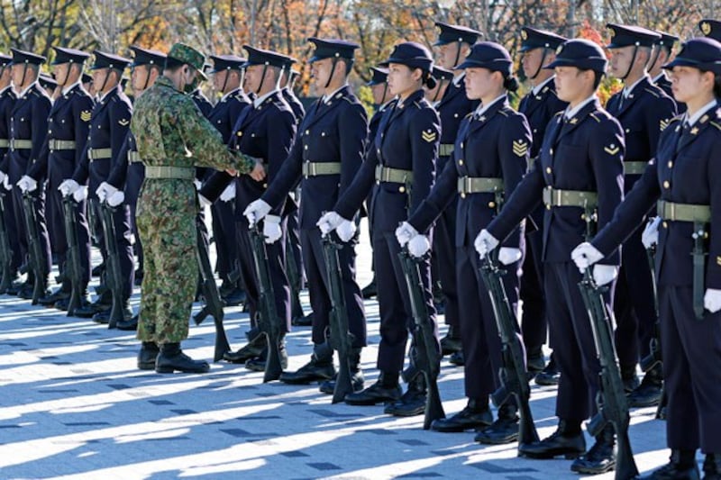 Japanese Ground Self-Defense Force honor guard troops prepare for a review at Camp Asaka in Tokyo, Nov. 27, 2021. Credit: Associated Press