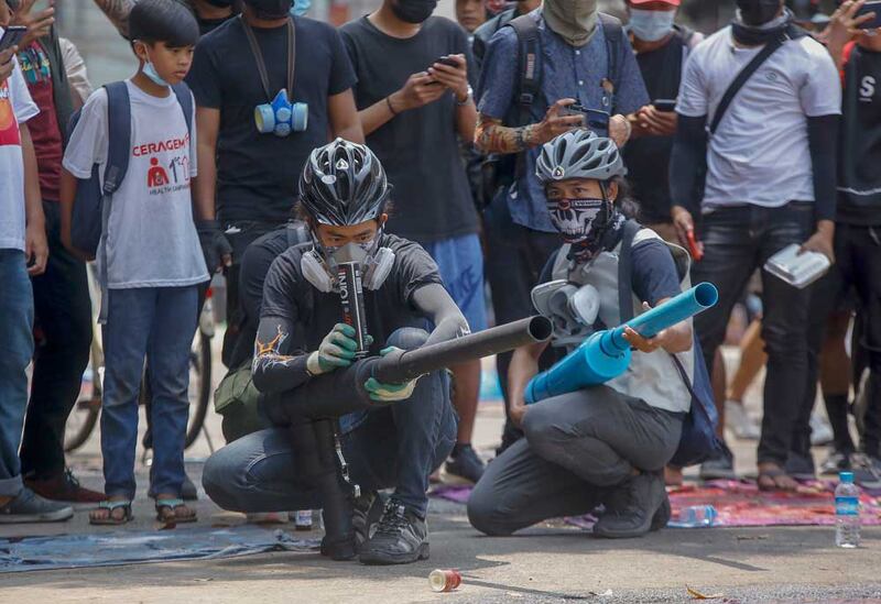 Protesters test improvised weapons in Yangon on Wednesday. Associated Press photo