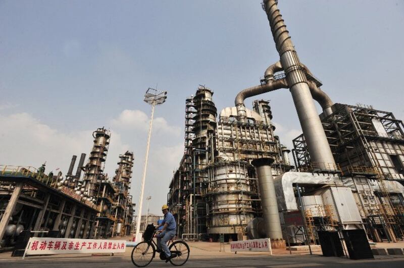 A worker rides a bicycle at a Sinopec oil refinery in Wuhan, Hubei province, in a file photo.