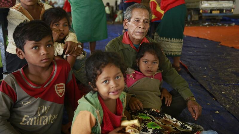 Villager Phon Vuongchonpu and his grandchildren take refuge at a shelter in Paksong town, Champasak province, Laos on Wednesday, July 25, 2018. 