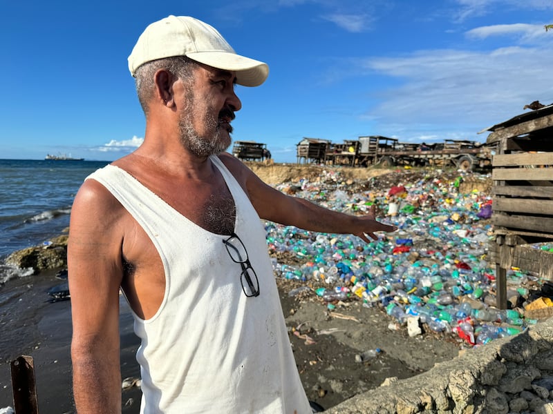 Solomon Islands environmental campaigner Lawrence Maliki points towards plastic waste clogging the coastline of the Solomon Islands capital Honiara on Nov. 27, 2024.