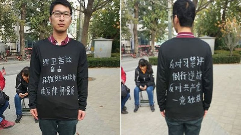 Qi Yiyuan, a 29-year-old resident of Jiangsu province in eastern China, wearing a jacket with slogans attacking the Chinese Communist Party and President Xi Jinping.