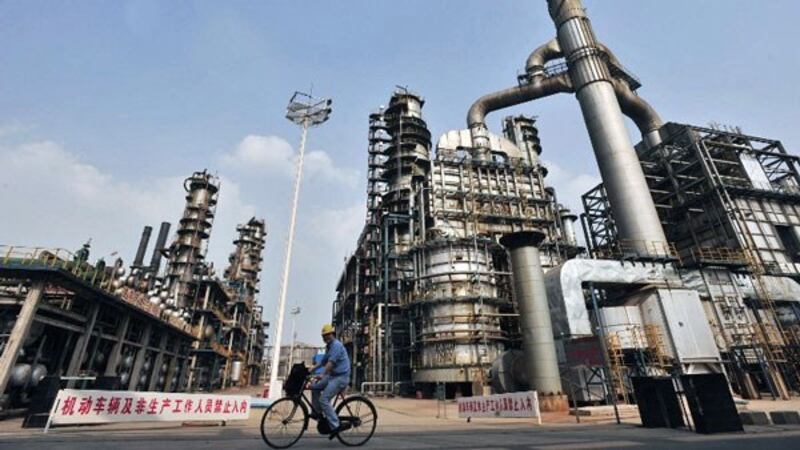 A worker rides a bicycle at a Sinopec oil refinery in Wuhan, central China's Hubei province, in a file photo. 