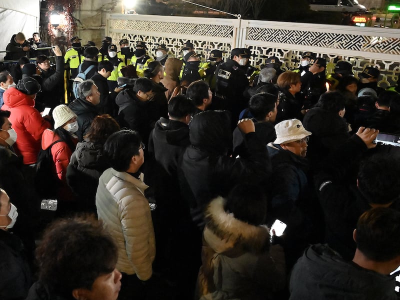 People gather in front of the main gate of the National Assembly in Seoul, on Dec. 4, 2024, after President Yoon Suk Yeol declared emergency martial law.