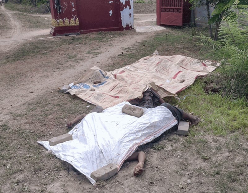 The dead bodies of civilians from Kan Pyar village, Myinmu township, in northwestern Myanmar's Sagaing region, lay covered on the ground, June 6, 2022. Credit: Citizen journalist