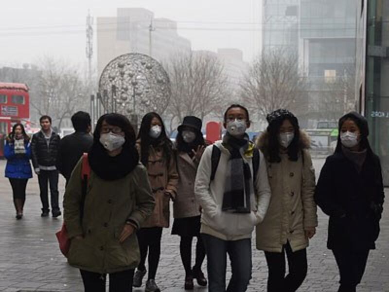 Chinese women wear face masks on a heavily polluted day in China's capital Beijing, Dec. 26, 2015. 