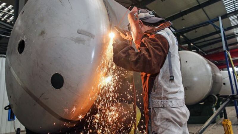 A Chinese worker welds a liquefied natural gas tank at a factory in Nantong, eastern China's Jiangsu province, March 14, 2019. 