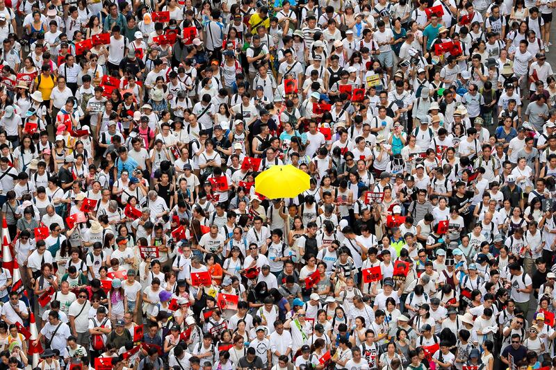 A protester holds up a yellow umbrella as he marches with thousands of others in a rally against the proposed amendments to extradition law in Hong Kong, June 9, 2019. (Kin Cheung/AP)