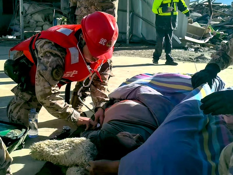 Rescue workers check on an injured resident in the aftermath of an earthquake in Changsuo Township of Dingri in Xigaze, southwestern China's Tibet Autonomous Region, Jan. 7, 2025.