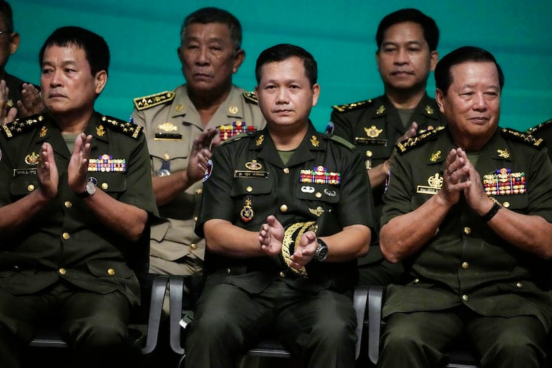 Cambodian army chief Hun Manet [center], son of Cambodian Prime Minister Hun Sen, attends a ceremony of the Royal Cambodian Armed Forces at the Defense Ministry in Phnom Penh, Cambodia, Thursday, April 20, 2023. Hun Manet, who is widely expected to replace his father, Hun Sen, as the country's prime minister later this year, was promoted on Thursday to his country's highest military rank. Credit: Associated Press