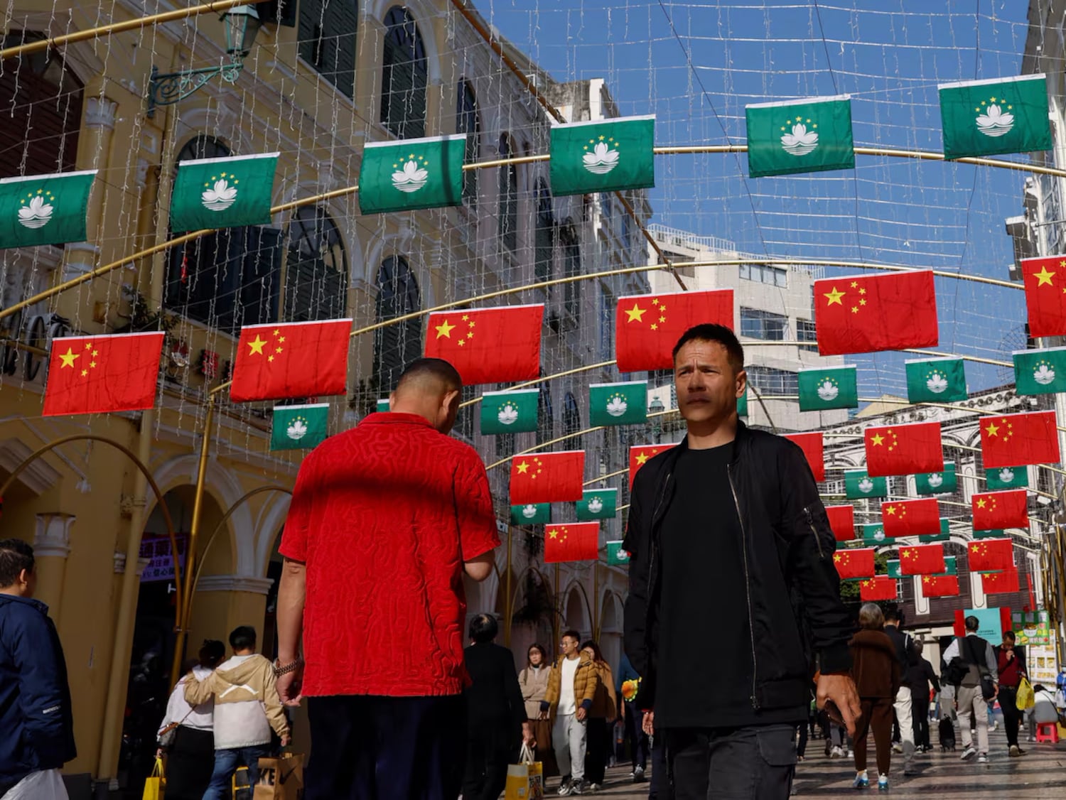 Chinese five-star flags and the flag of the Macao Special Administrative Region are hung in a square in front of the Senate in Macao.