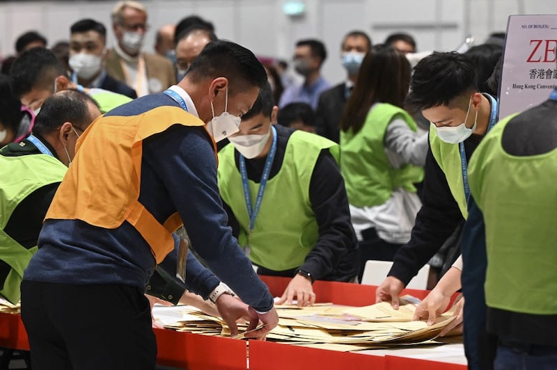 Election officials start to count the first ballot papers after polls closed in the Legislative Council elections in Hong Kong, Dec. 19, 2021. Credit: AFP