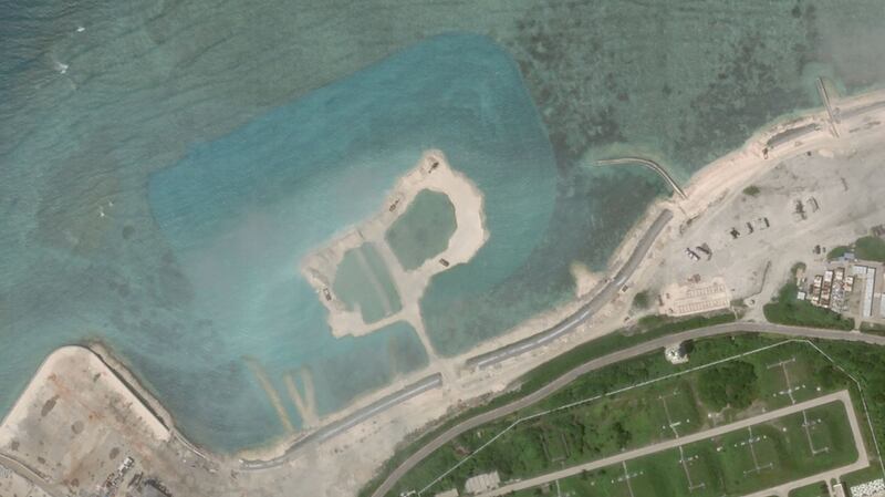 Satellite imagery dated Oct. 5 shows a patch of reef in Woody Island's northwest that has been dredged up, as indicated by the blue color of the water around it. 