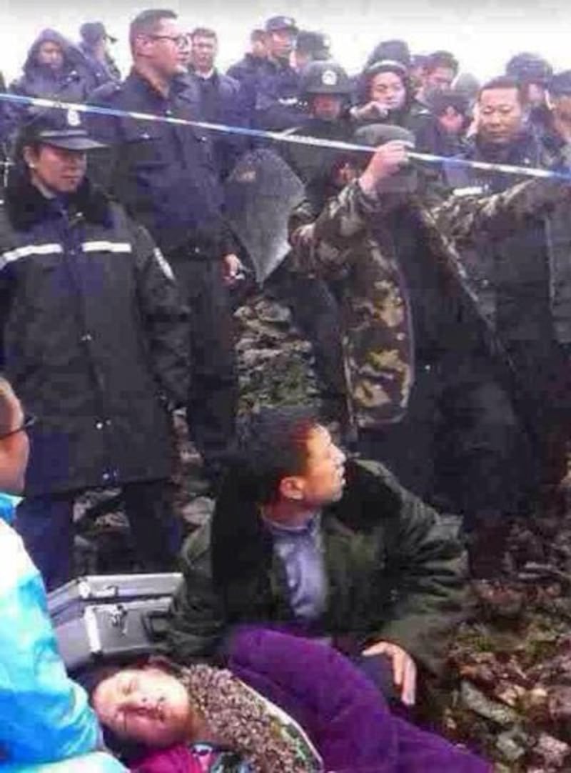 A fallen protester is helped by a friend in Dechen, June 30, 2014. Credit: RFA listener