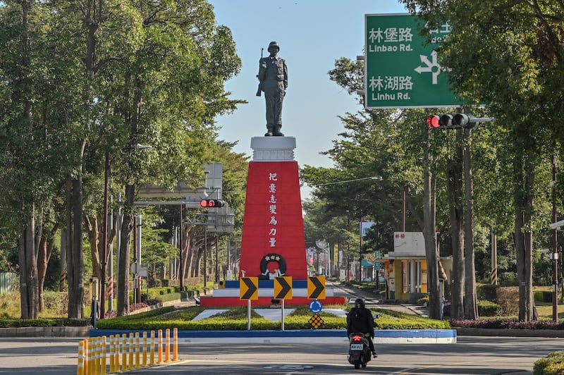 This Dec. 7, 2023 image shows a statue with a banner that reads "Turn your Will into Strength" in Kinmen. It is one of many reminders of the conflict decades earlier with Chinese communist forces. (Sam Yeh/AFP)