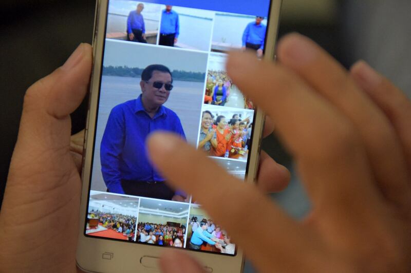 A Cambodian man in Phnom Penh browses photos of Cambodian Prime Minister Hun Sen on the leader's Facebook page. Credit: AFP file photo