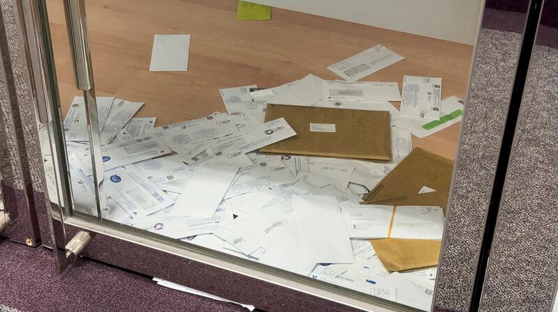 Unopened mail including utility bills inside an empty office in Hong Kong's high-end skyscraper The Center, July 2024. (Wei Sze/RFA)