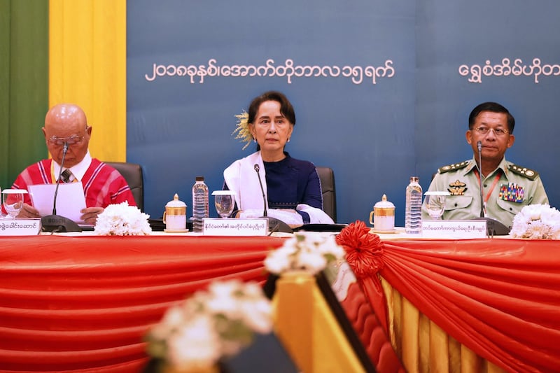 Myanmar's detained civilian leader San Suu Kyi, presides at a meeting in Naypyidaw with then military chief Senior Gen. Min Aung Hlaing and chairman of the Karen National Union Gen. Saw Mutu Say Poe to commemorate the third anniversary of signing of Myanmar's Nationwide Ceasefire Agreement on Oct. 15, 2018. Credit: Myanmar State Counselor Office via AFP