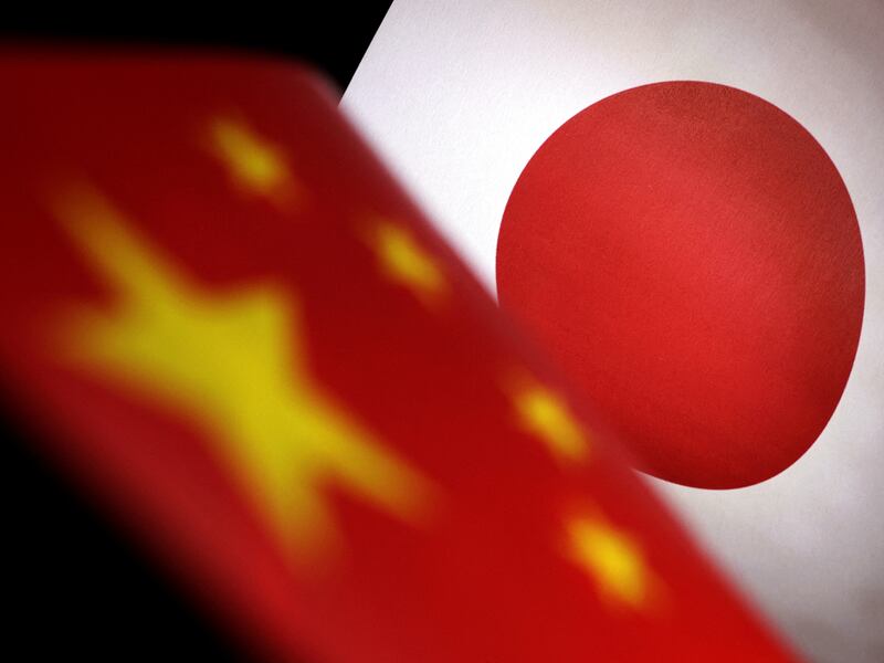 An illustration of printed Chinese and Japanese flags July 21, 2022.