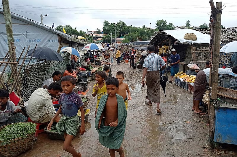 Rohingya refugees walk along a path at Kutupalong refugee camp in Ukhia, Bangladesh, Aug. 25, 2021. Credit: AFP