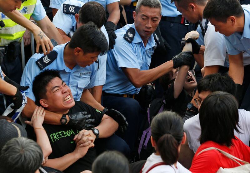 Police haul away protesters after a peaceful overnight sit-in. (Associated Press)