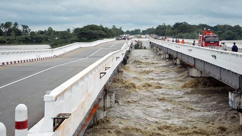 A bridge along the Yangon-Mandalay highway is damaged by raging floodwater in the Swar River in central Myanmar's Bago region, Aug. 29, 2018.