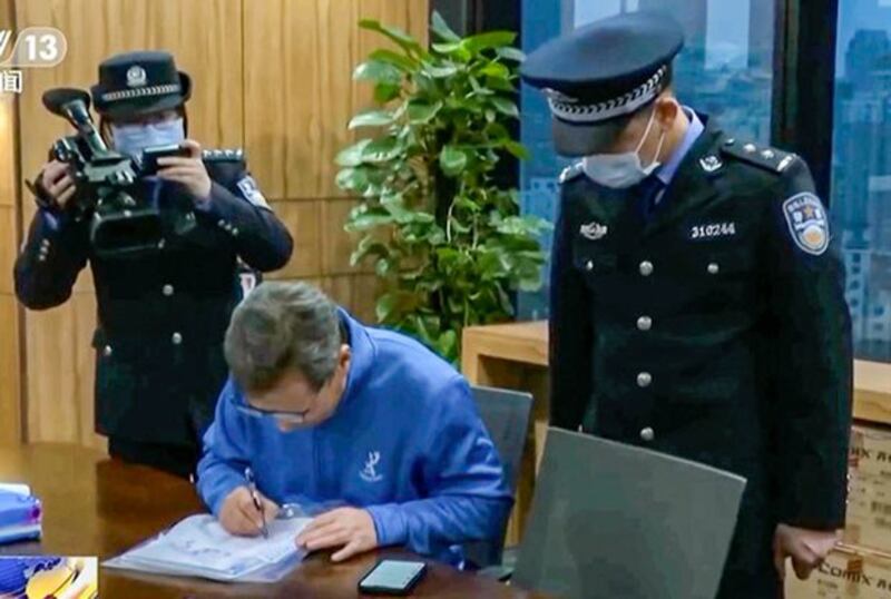 Chinese police conduct work during a raid of the Shanghai, China, office of international consultancy Capvison in an undated photo. (Screenshot from CCTV via AP)