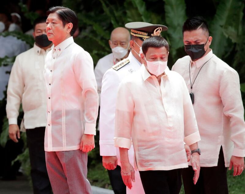 President Ferdinand Marcos Jr. (left) and his predecessor, Rodrigo Duterte, cross paths at the Malacañang Palace grounds during the official handover ceremony, June 30, 2022. Credit: BenarNews/FOCAP pool