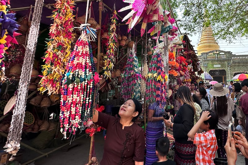 Visitors browse at the annual Shwe Saryan Pagoda harvest festival in Shwe Saryan village, Patheingyi township, Mandalay region, Myanmar, March 11, 2025.