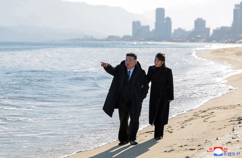 This picture taken on Dec. 29, 2024 and released on Dec. 31, 2024 shows North Korea’s leader Kim Jong Un (L) and his daughter Ju Ae walking on the beach during a visit to the “Kalma Coast Tourism Area” in the North Korean city of Wonsan.