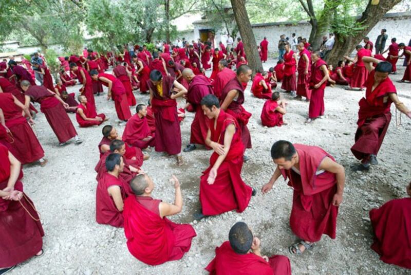 Tibetan monks debate Buddhist philosophy at Sera Monastery in Lhasa, Tibet, August 25, 2003. (Guang Niu/Reuters)