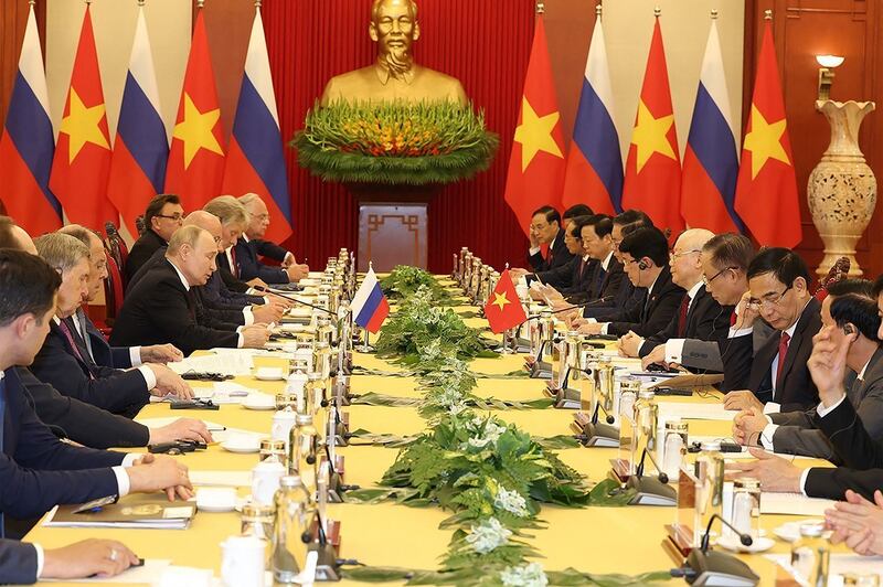 General Secretary of Vietnam's Communist Party Nguyen Phu Trong, fourth from right, meets with Russia's President Vladimir Putin, center left, in Hanoi, June 20, 2024. (Vietnam News Agency via AFP)