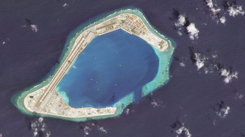 A satellite image taken Feb. 28, 2020 shows vessels at Subi Reef, an artificial island constructed by China in the Spratly island chain in the South China Sea. Chinese ships can only sustain their pressure campaigns far from mainland China if they can dock and replenish at such locations. 