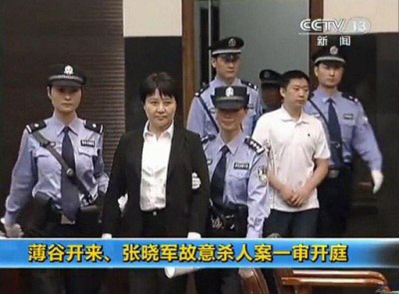 A CCTV screen grab shows Gu Kailai (c) being escorted into the courtroom for her murder trial in Hefei, Aug. 9, 2012. Credit: AFP. 