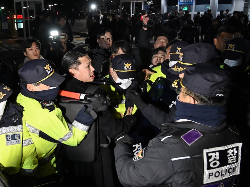 Police attempt to hold back people trying to enter the National Assembly in front of the main gate of the National Assembly in Seoul, on Dec 3, 2024.