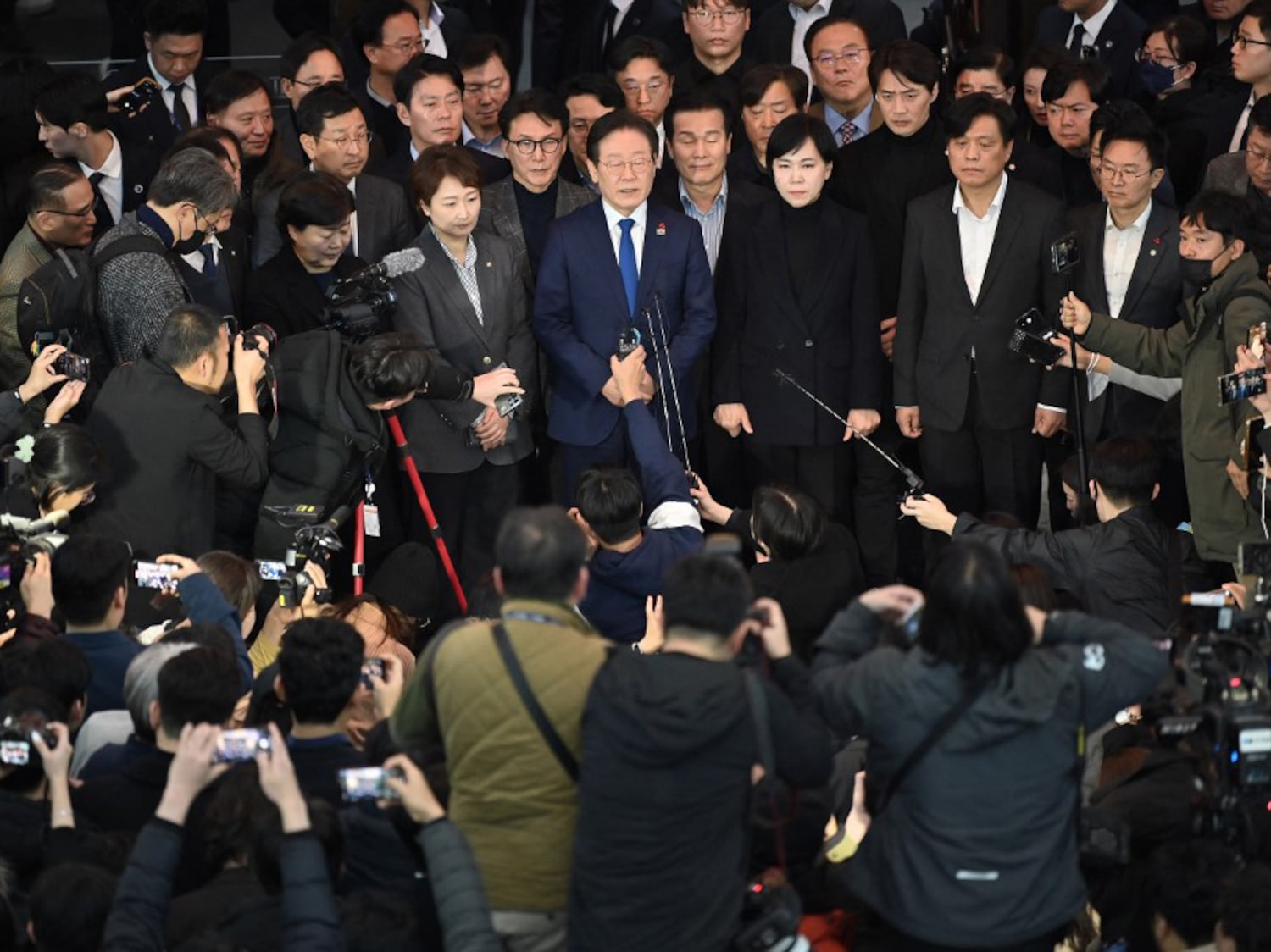 South Korea's main opposition Democratic Party leader Lee Jae-myung (C) speaks to the media at the National Assembly in Seoul on Dec. 4, 2024, after South Korea President Yoon Suk Yeol declared martial law.