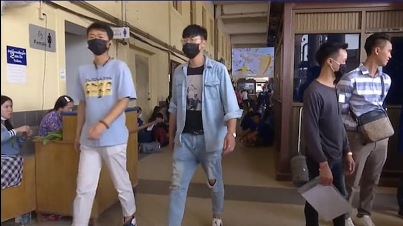 Workers wear masks to protect against the spread of the coronavirus in an office in Vientiane, Nov. 23, 2020.