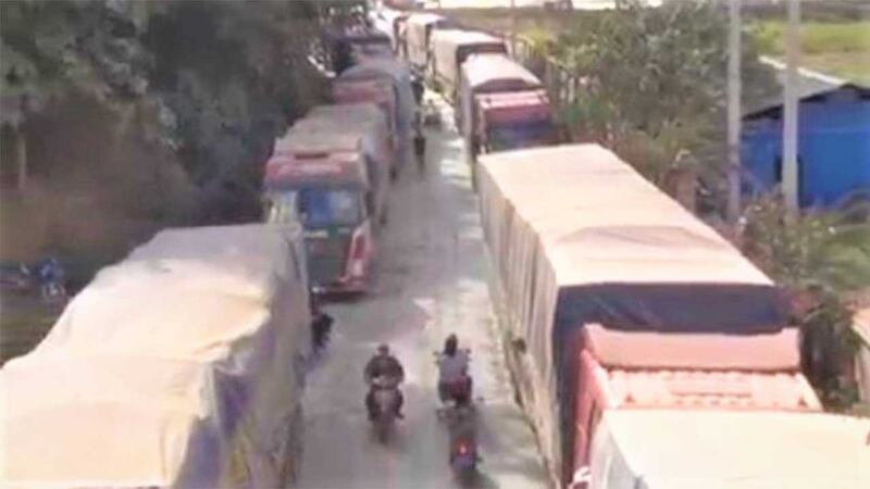 Trucks line up waiting the cross the Lao-China border, in a screengrab of a video broadcast by state-run Luang Namtha Provincial TV, Dec. 29, 2021.