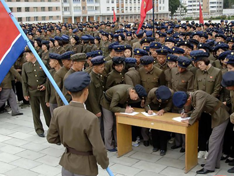 Young people sign petitions to join, or return to, the army, at an undisclosed location in North Korea, in this undated photo released Oct. 16, 2024.