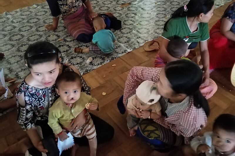 Women and their babies, displaced by recent fighting between government security forces and ethnic rebels in their area, take refuge at a monastery in Namlan township, Shan state, Myanmar, May 25, 2021. Credit: AFP/ MNWM/Shwe Phee Myay News Agency