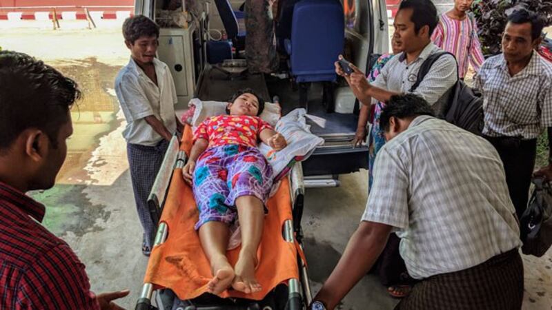 A child injured by mortar shell explosions in western Myanmar's war-ravaged Rakhine state arrives at a hospital in Sittwe, Oct. 3, 2019.