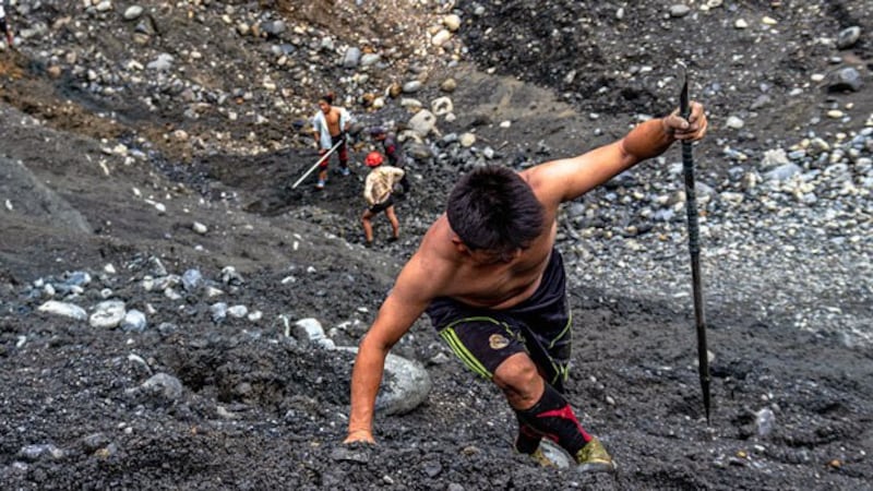 A jade prospector makes his way up a slag heap at a mine near Ma Mon village in Hpakant township, northern Myanmar's Kachin state, July 9, 2020.