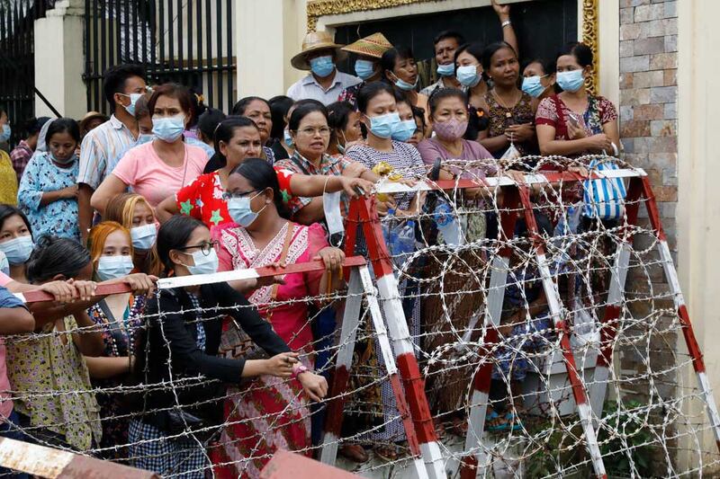 Friends and family members wait, hoping for the release of their loved ones Wednesday in Yangon. Myanmar's government began releasing about 2,300 prisoners, including activists and reporters. (Citizen journalist)