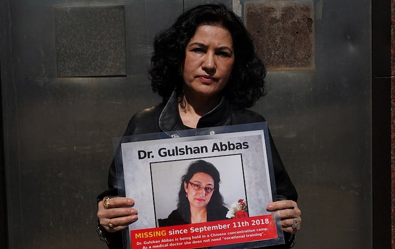 Rushan Abbas, executive chair of the World Uyghur Congress, holds a photo of her imprisoned sister, Gulshan Abbas during a rally in New York on March 22, 2021.