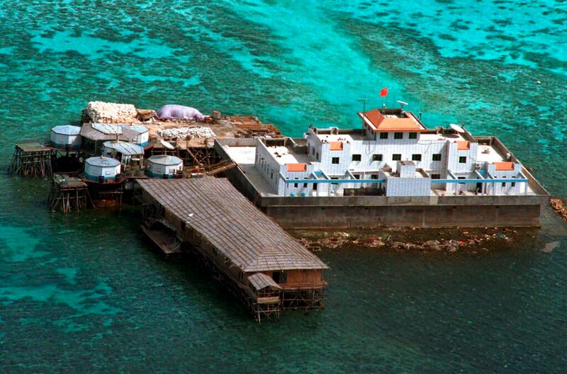 An airstrip made by China is seen beside structures and buildings at the man-made island on Mischief Reef at the Spratlys group of islands in the South China Sea, March 20, 2022. Credit: AP