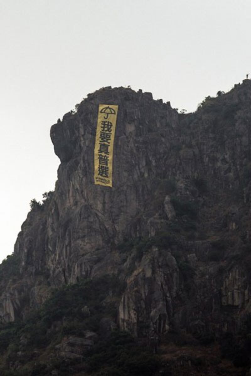 A large pro-democracy banner is displayed on Lion Rock Hill in Hong Kong, Oct. 23, 2014. Credit: AFP