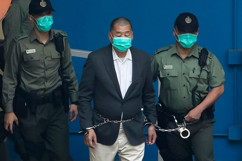 Correctional Services officers escort Jimmy Lai to appear in a court in Hong Kong, Dec. 12, 2020. (Kin Cheung/AP)